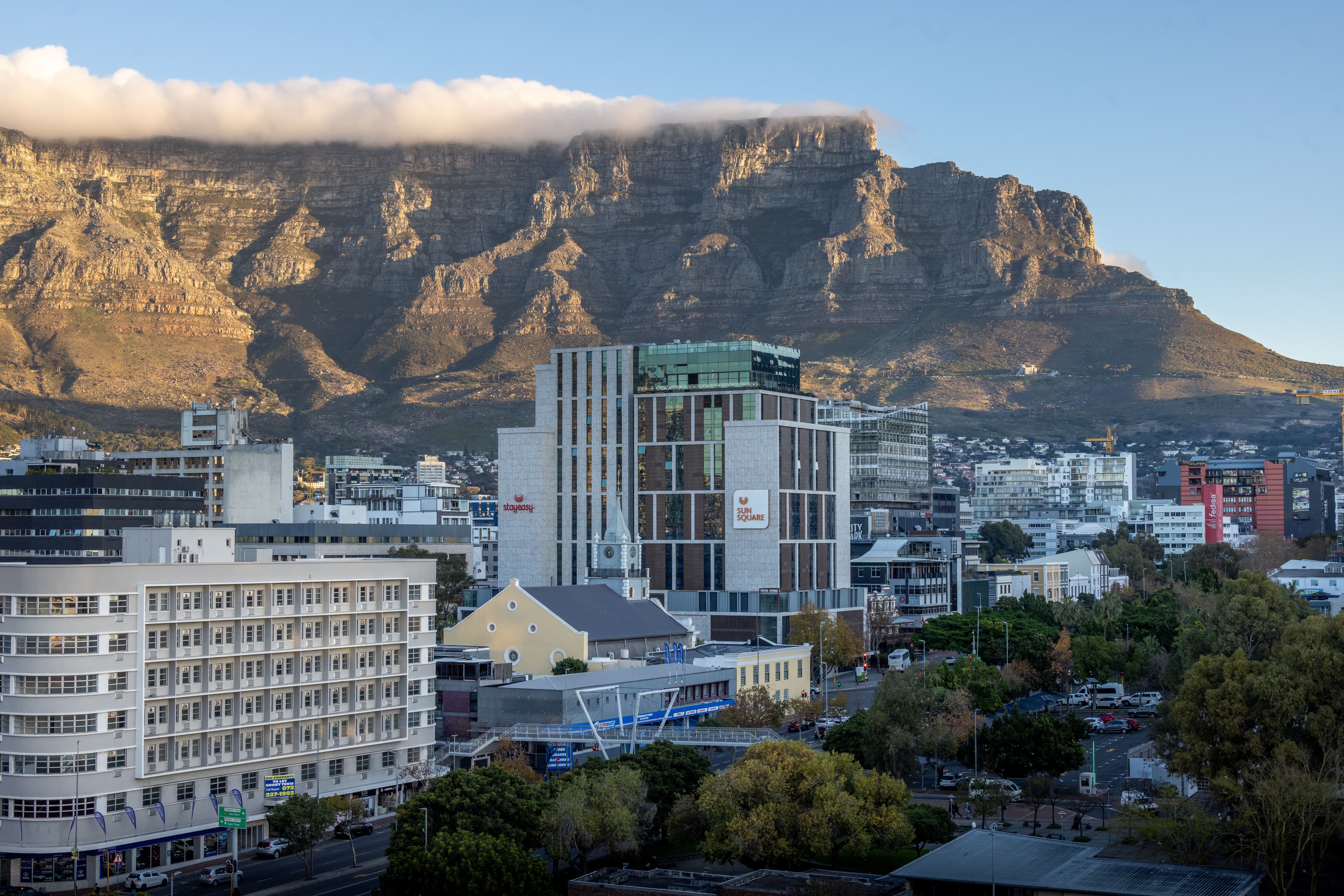 Runners along the Atlantic Seaboard promenade during the Sanlam Cape Town Marathon, Table Mountain visible above the city skyline