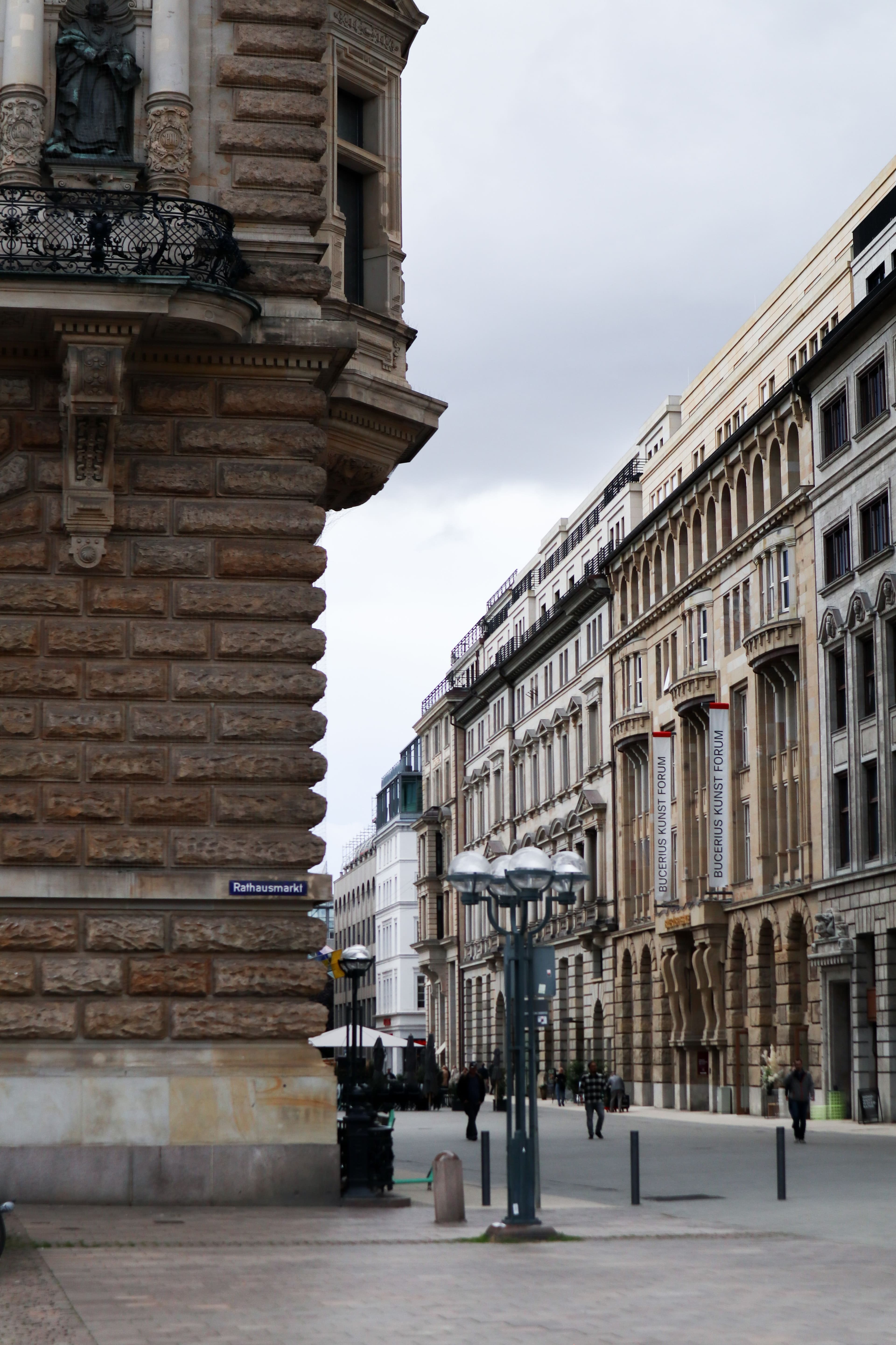 Rathausmarkt in central Hamburg, looking down a street of grand 19th-century facades away from the Rathaus
