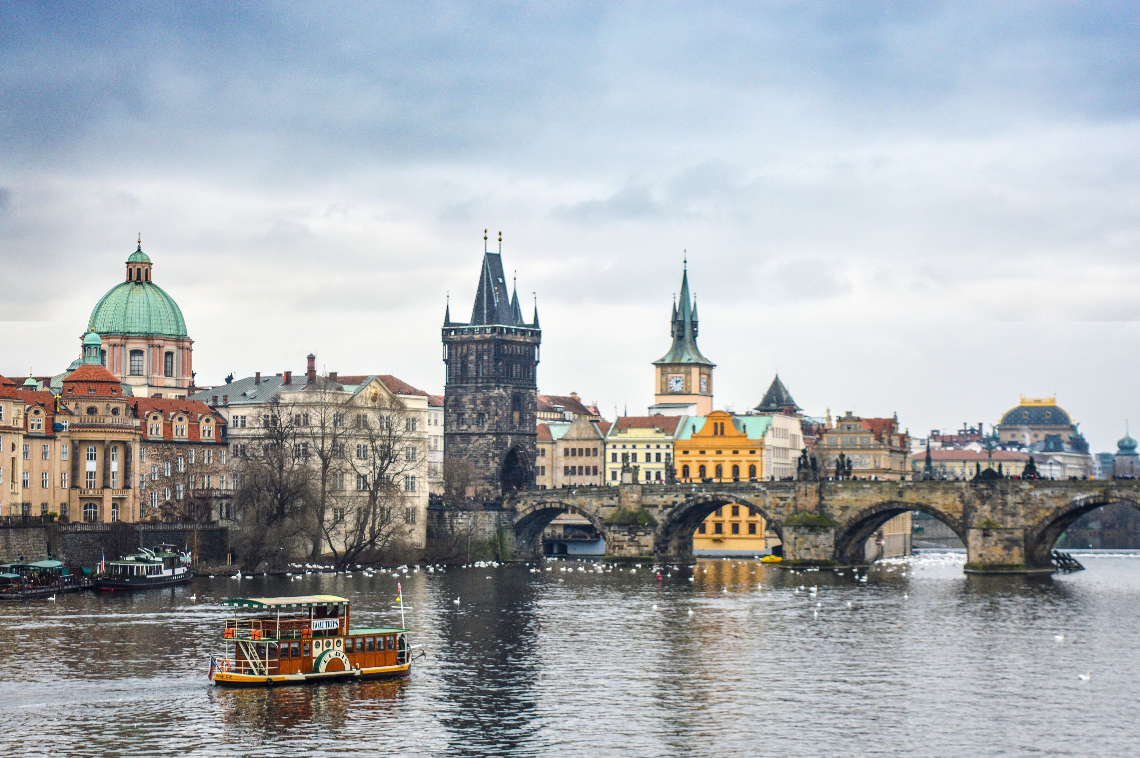 Charles Bridge and the Old Town Bridge Tower over the Vltava River, on the Prague Marathon's early course, seen from a Vltava boat