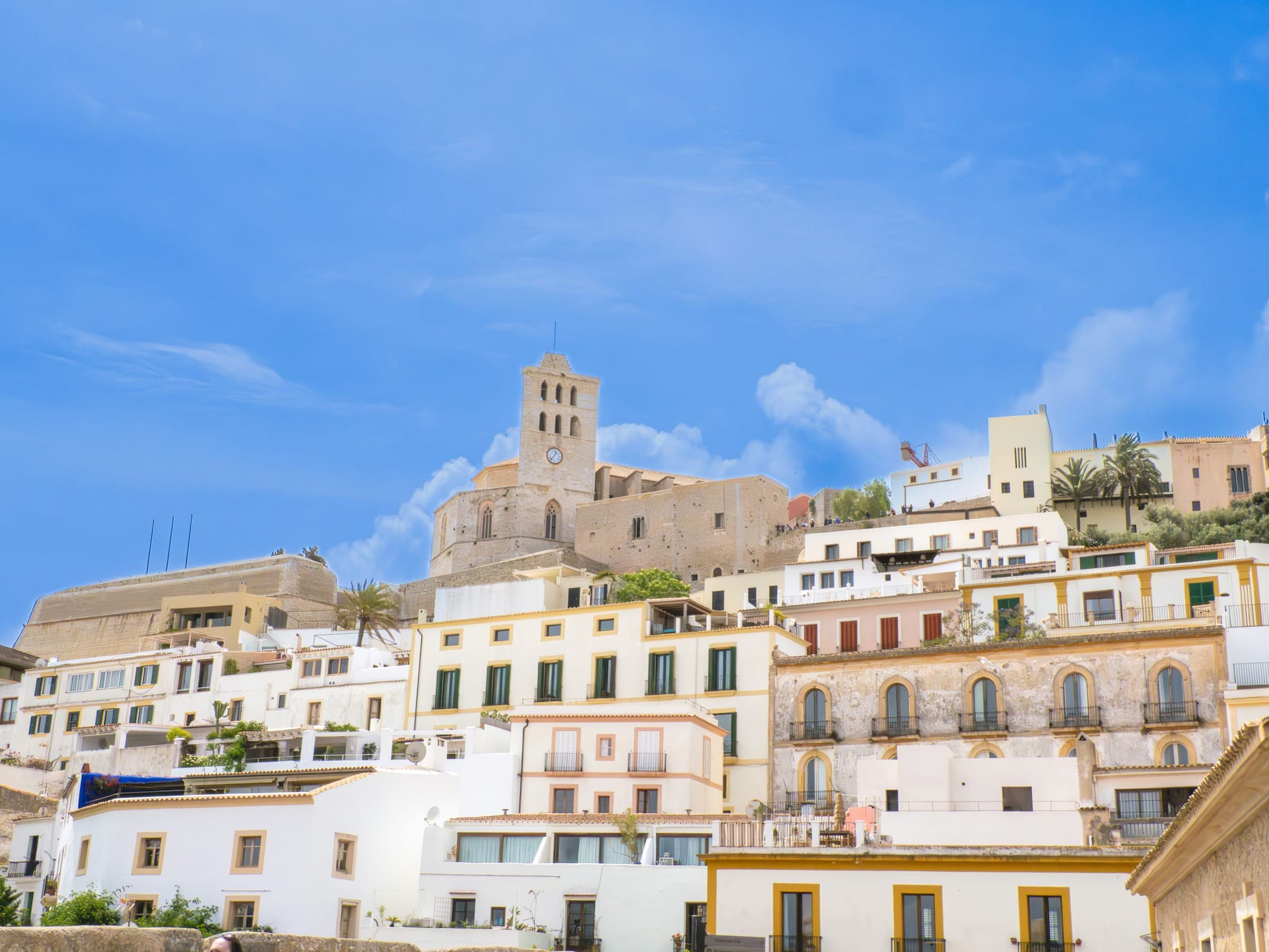 The white houses of Ibiza’s old town climbing to the cathedral tower and walls of Dalt Vila, above the port where the marathon starts