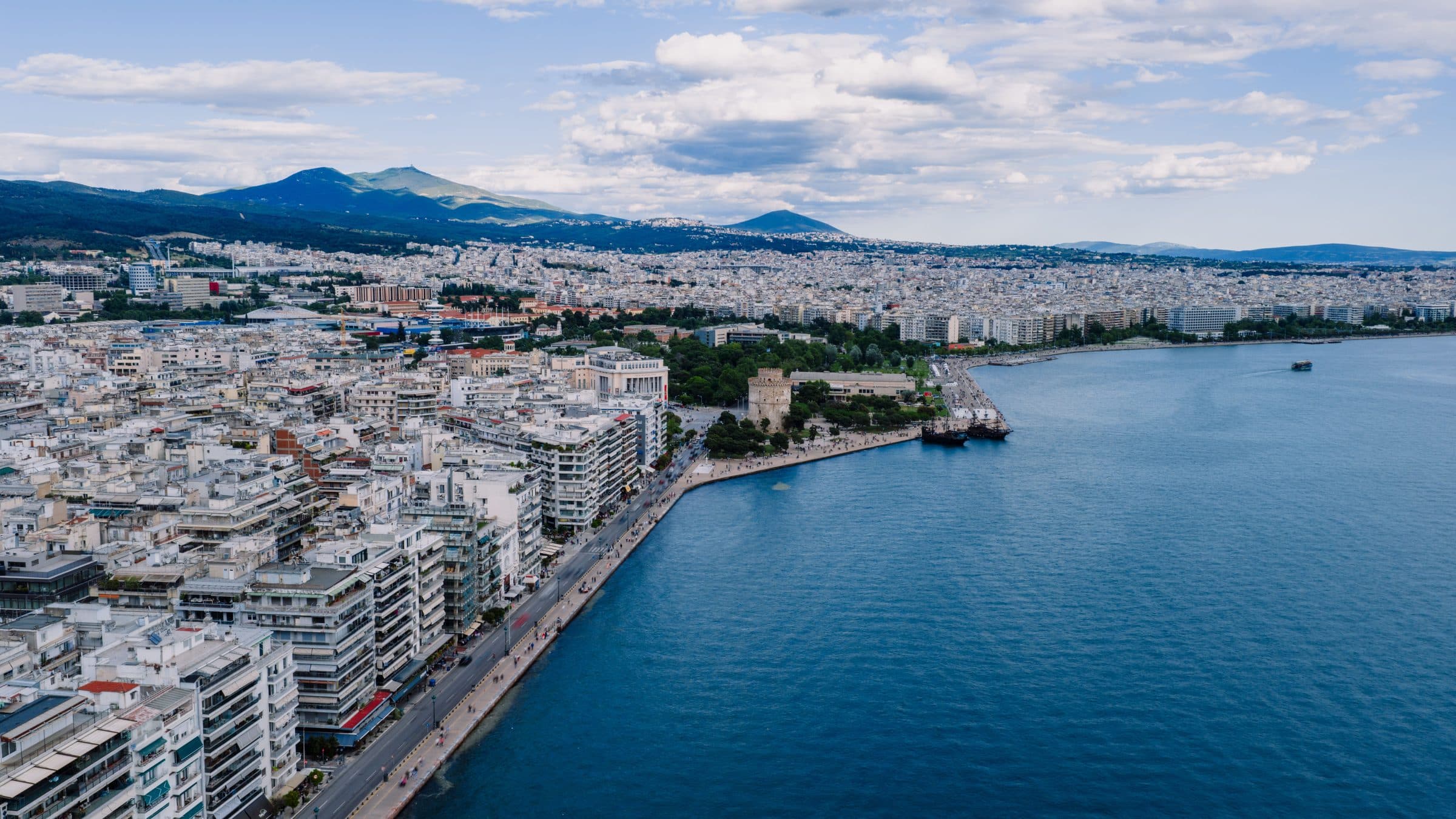 Aerial view of the Thessaloniki waterfront with the White Tower, the seafront promenade and the city rising towards the hills
