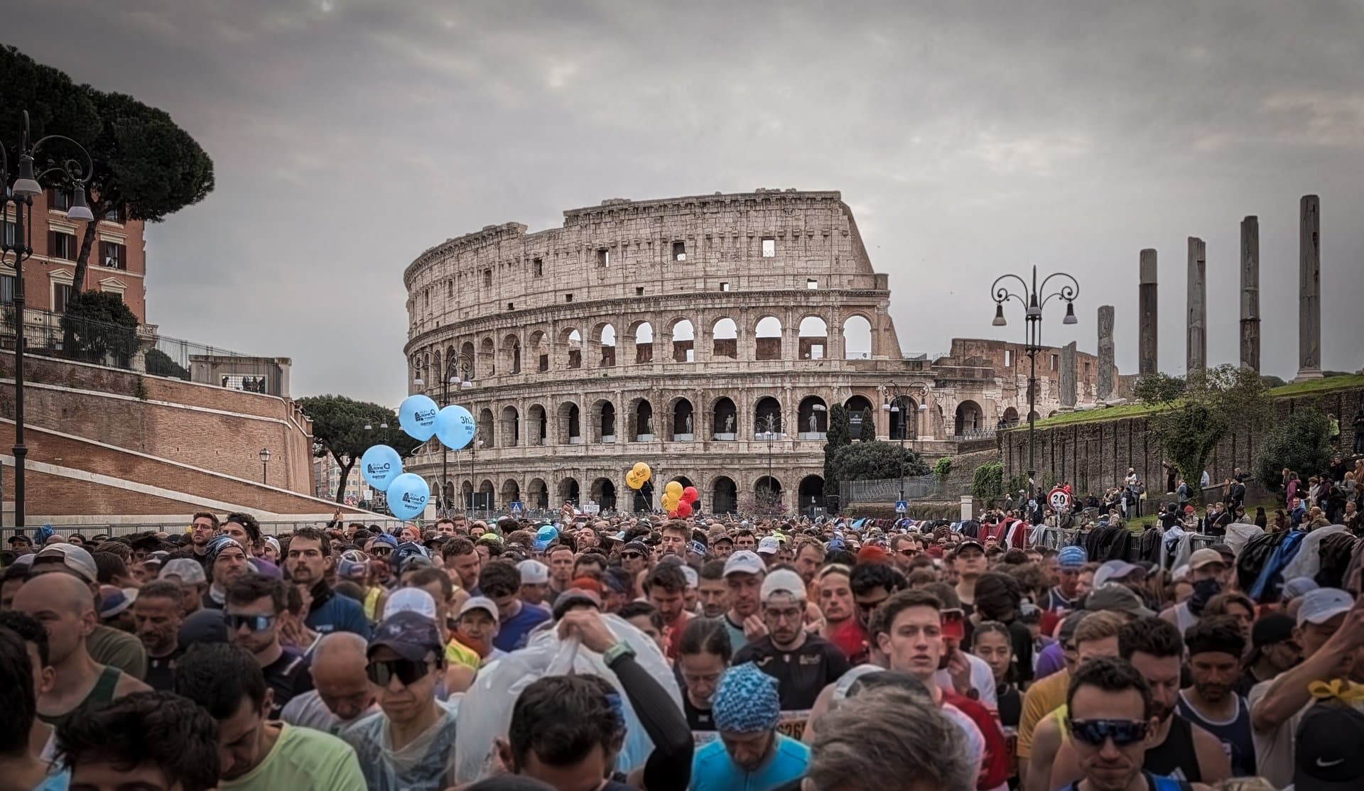 Fellow runners massed at the start of the Rome Marathon, the Colosseum rising directly ahead moments before the gun