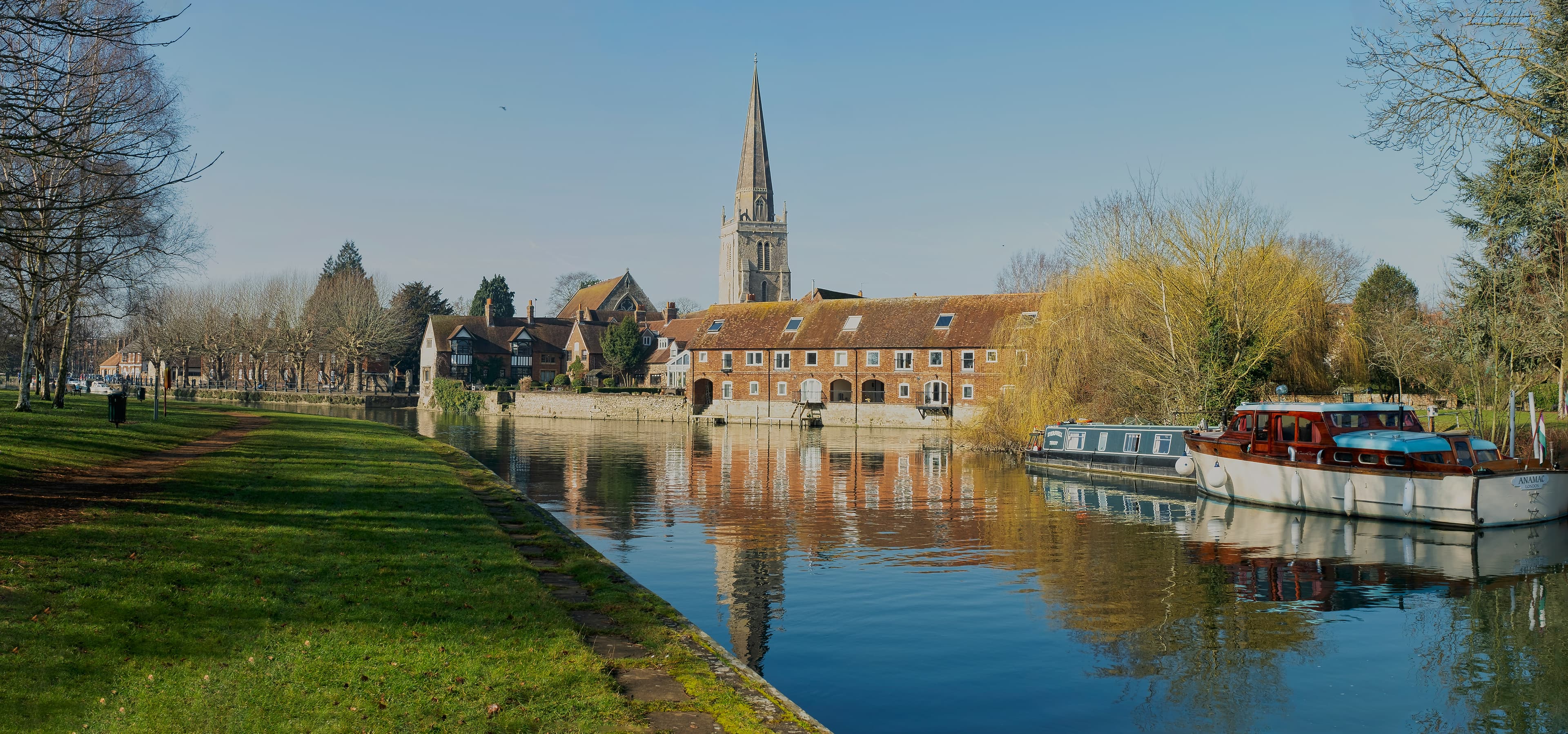 St Helen's Church spire and riverside cottages beside the River Thames in Abingdon, Oxfordshire, near the Abingdon Marathon's Tilsley Park start and finish