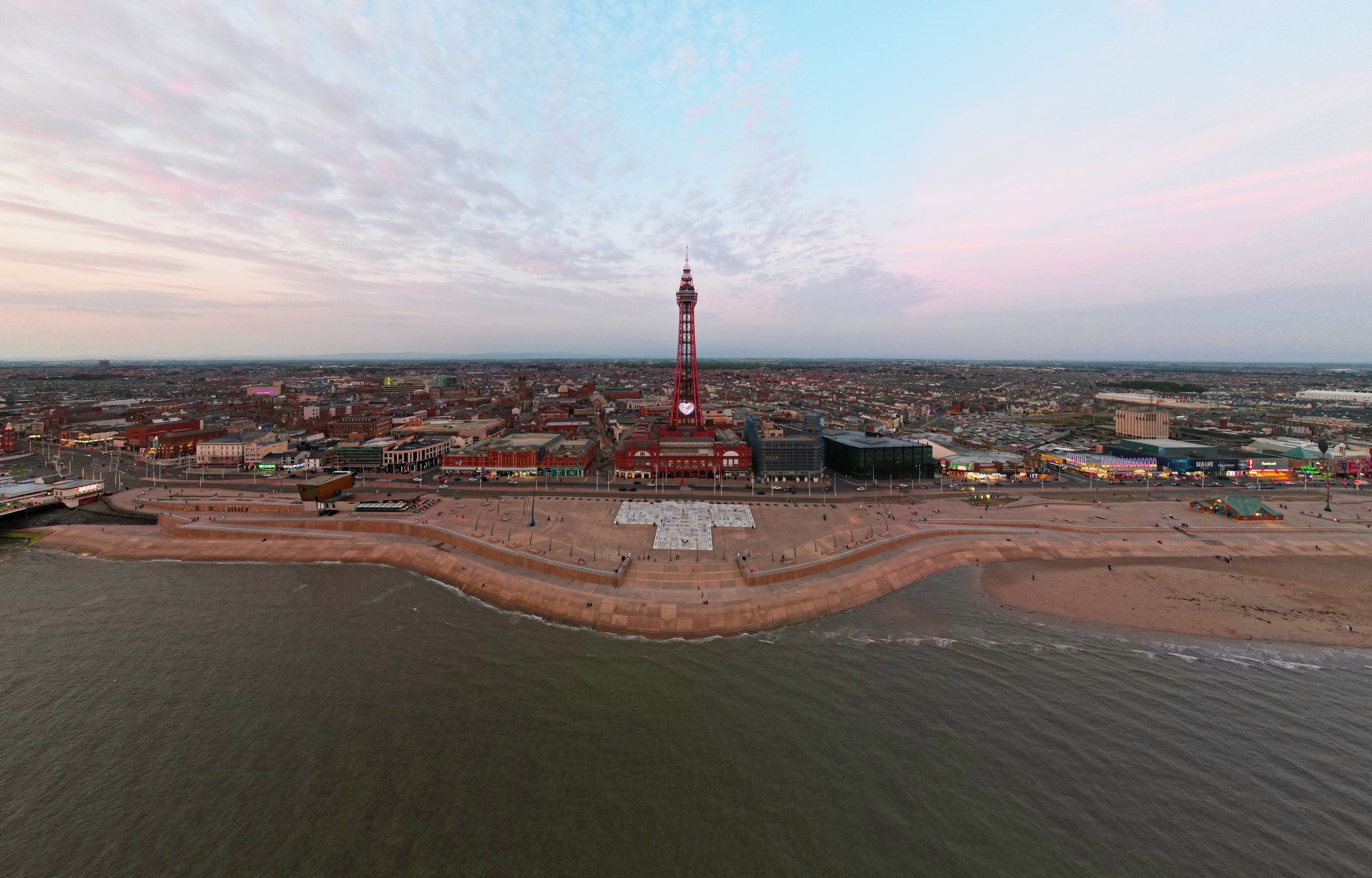 Blackpool Tower and the seafront promenade at dusk, near the Blackpool Marathon's Race HQ start and finish on the Middle Walkway