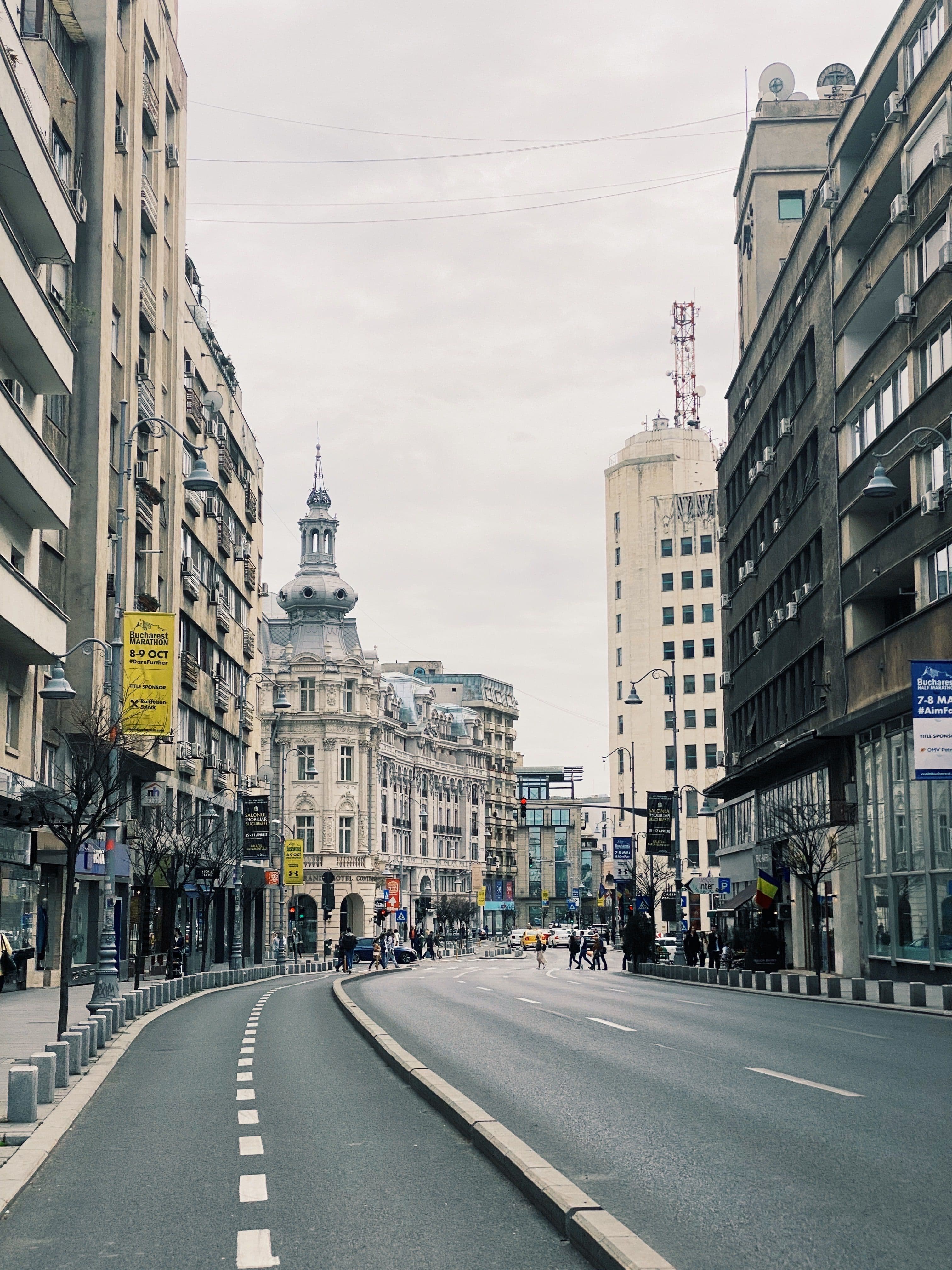 Calea Victoriei in Bucharest, one of the course's grand historic boulevards, with race-weekend banners visible on the lamp posts