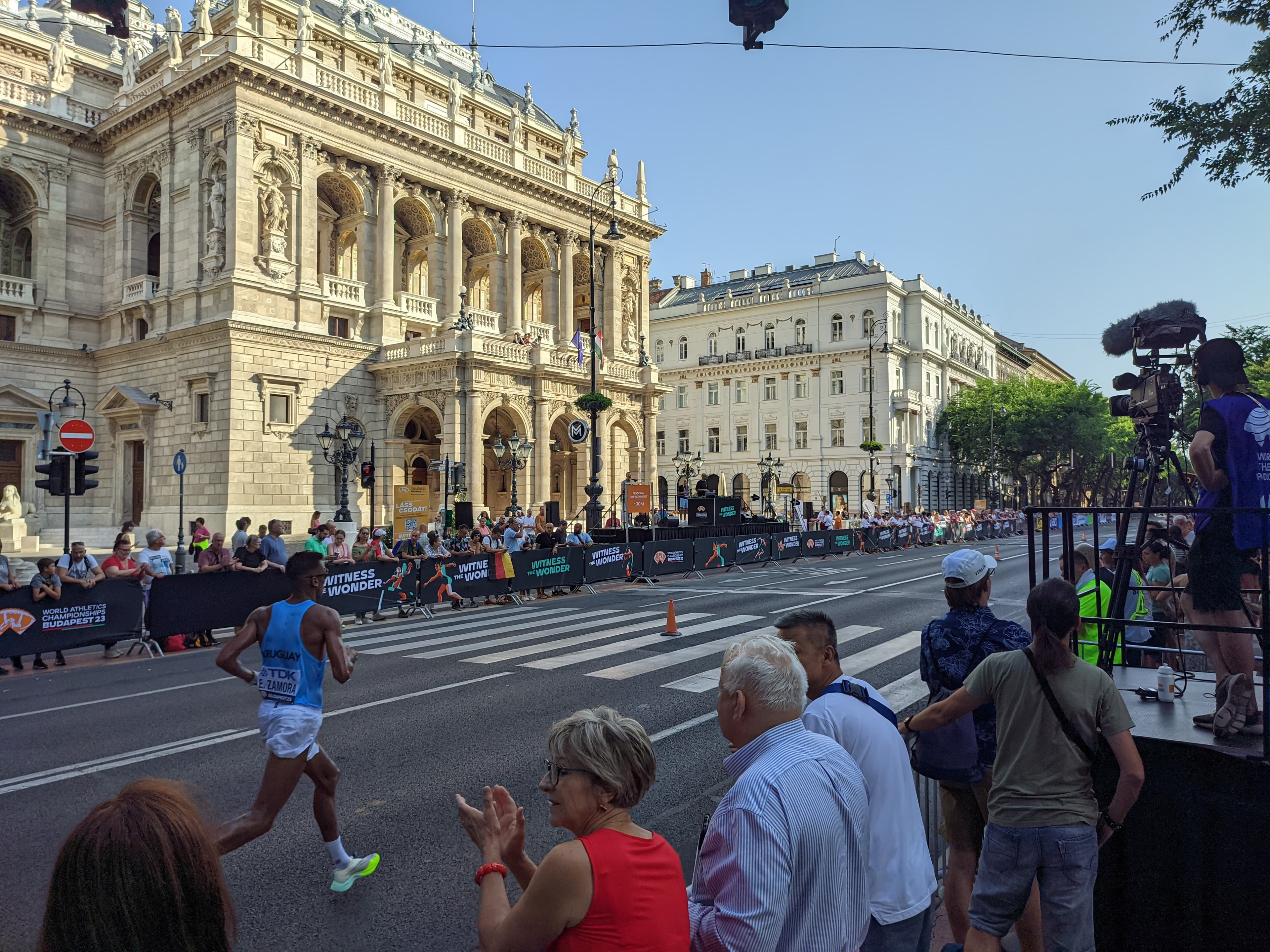 A marathon runner passing the Hungarian State Opera House on Andrássy Avenue during the 2023 World Athletics Championships in Budapest
