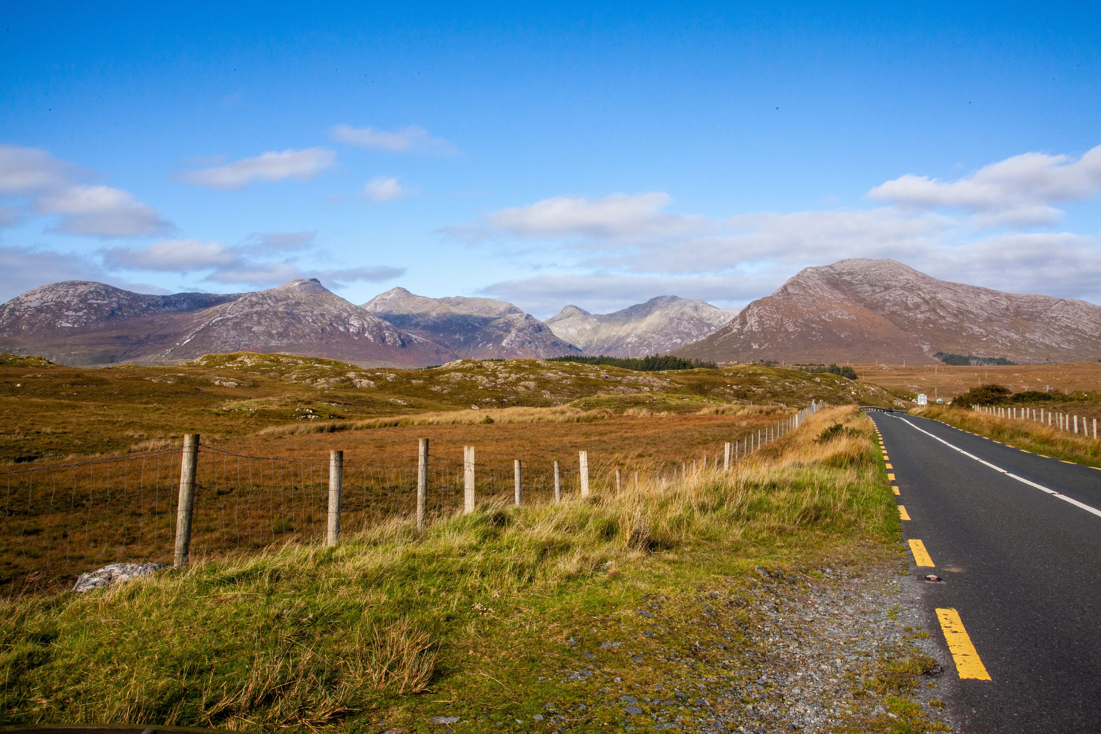 A rural Connemara road with the Twelve Bens mountains behind, the same landscape the marathon course crosses