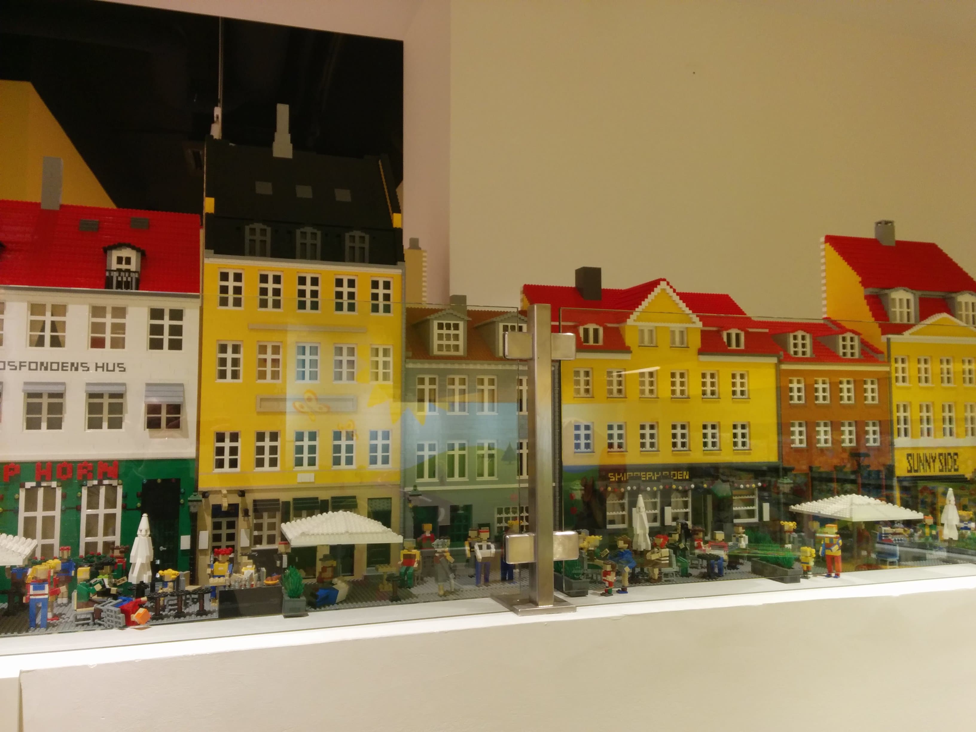 The colourful facades of Nyhavn harbour in Copenhagen with canal boats moored alongside