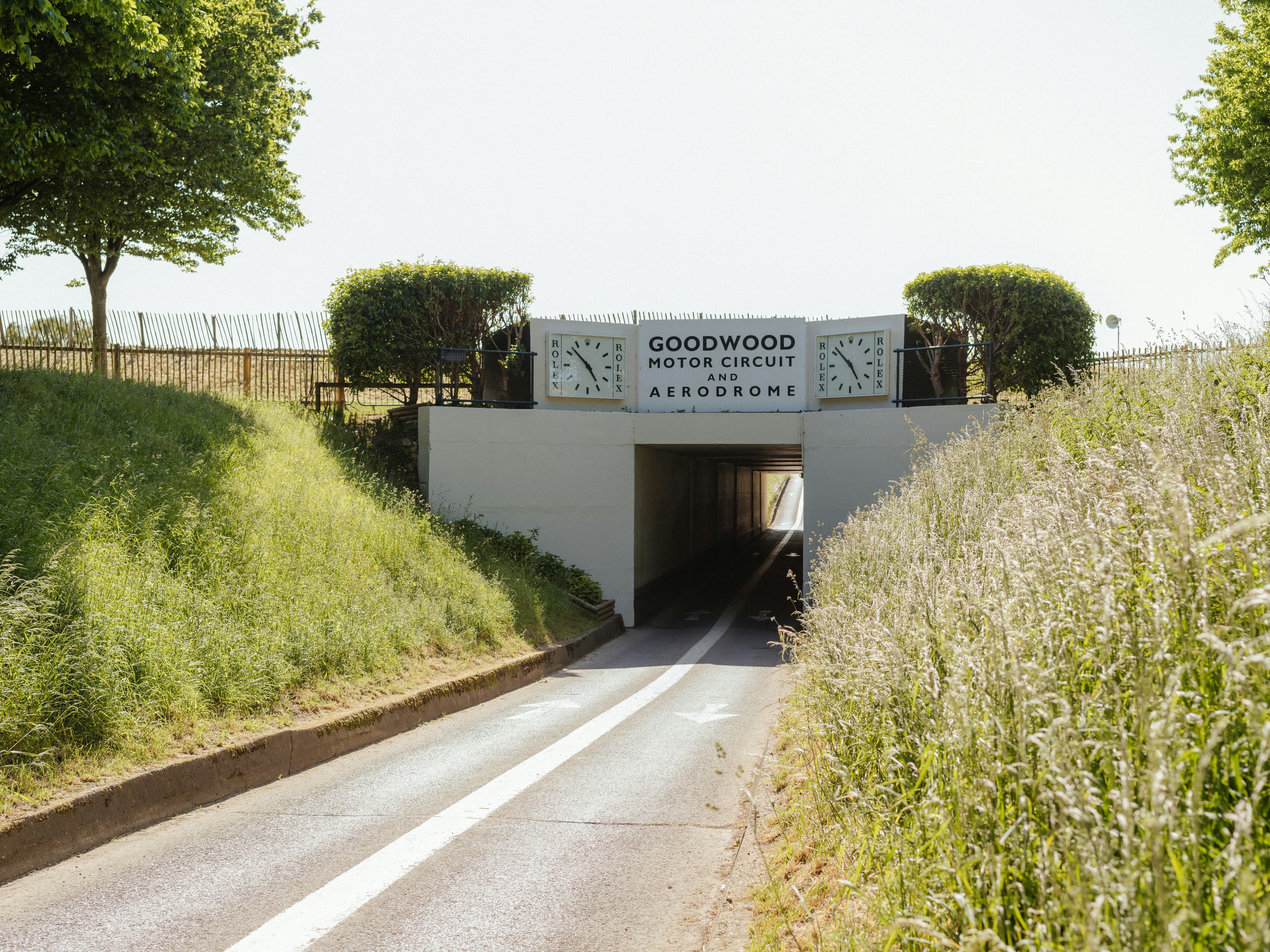 The tunnel entrance to Goodwood Motor Circuit and Aerodrome, near Chichester, marked with twin Rolex clocks, close to the Goodwood Marathon's start and finish