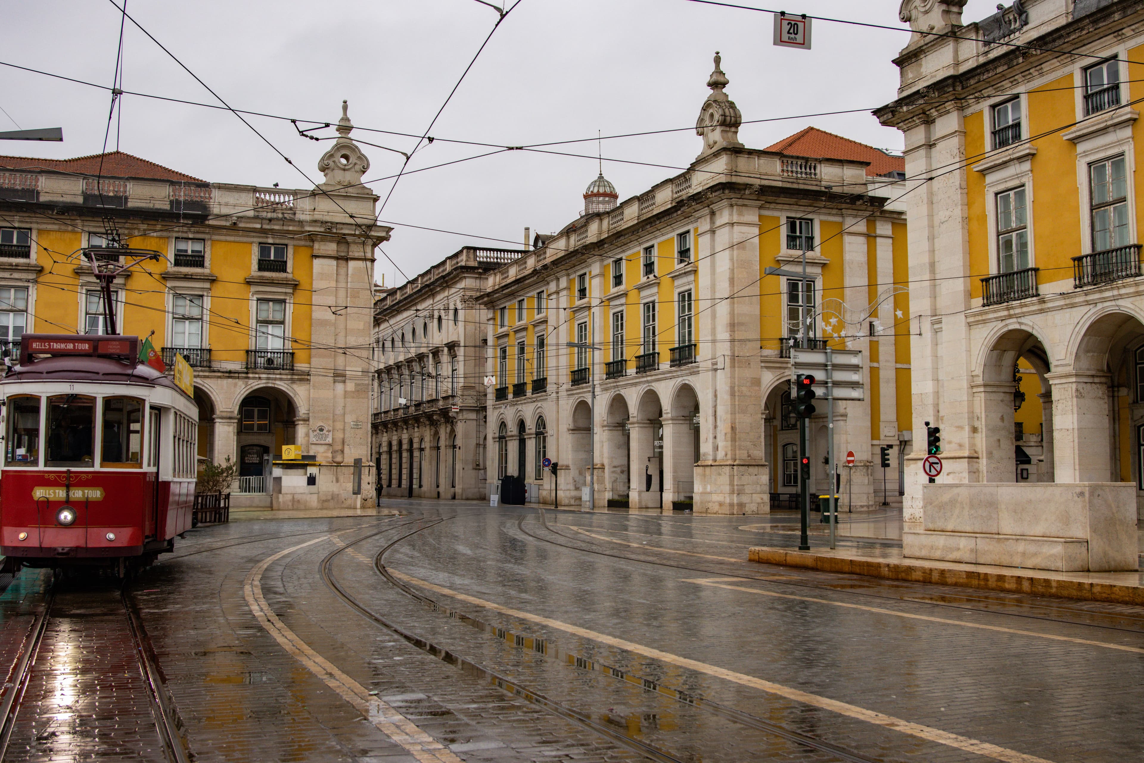 Traditional tram in Lisbon's Praça do Comércio on a rainy day