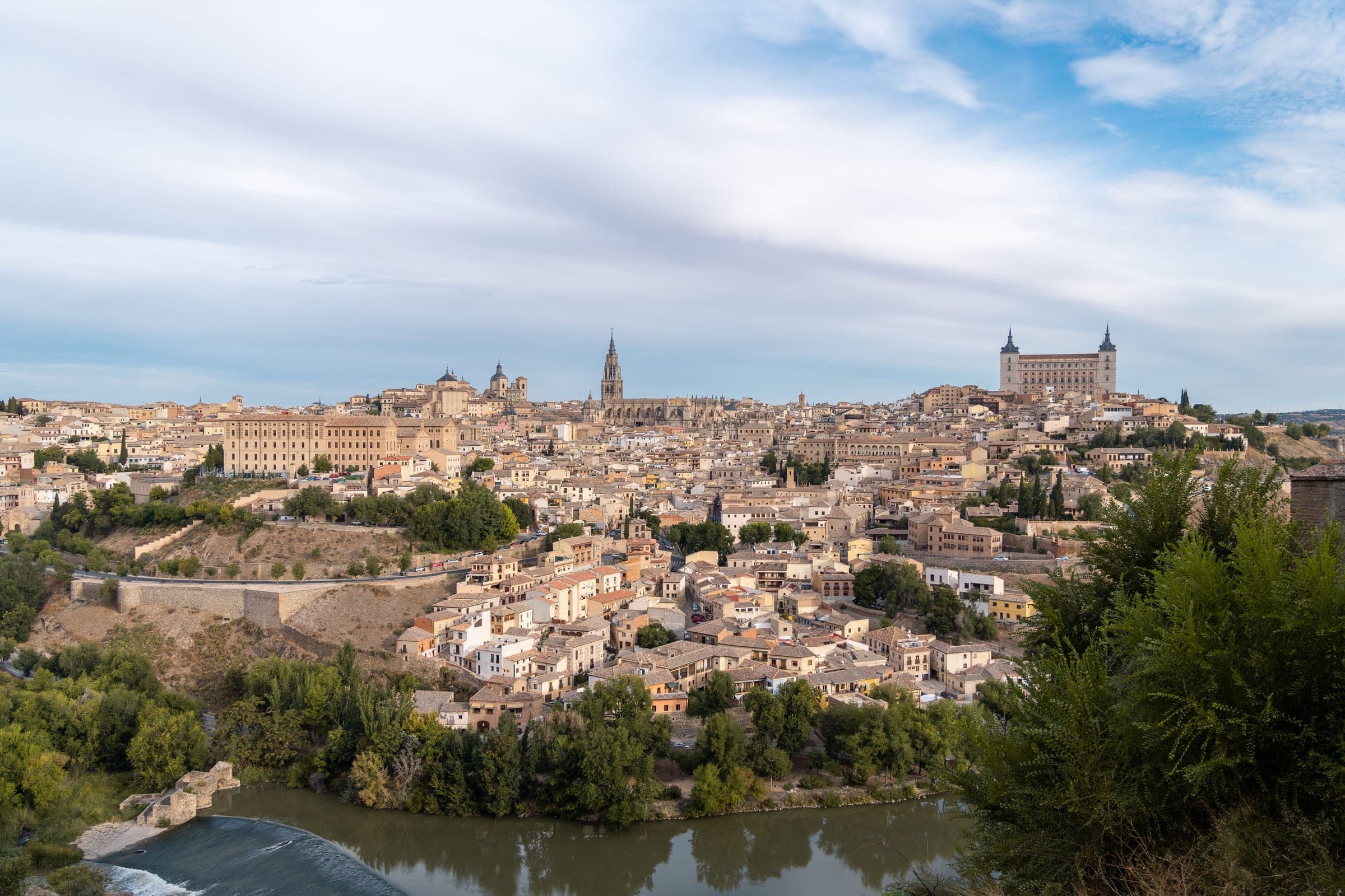Toledo’s old town on its hill above the Tagus, with the cathedral spire and the Alcázar on the skyline, seen from across the river near the Mirador del Valle where the marathon starts