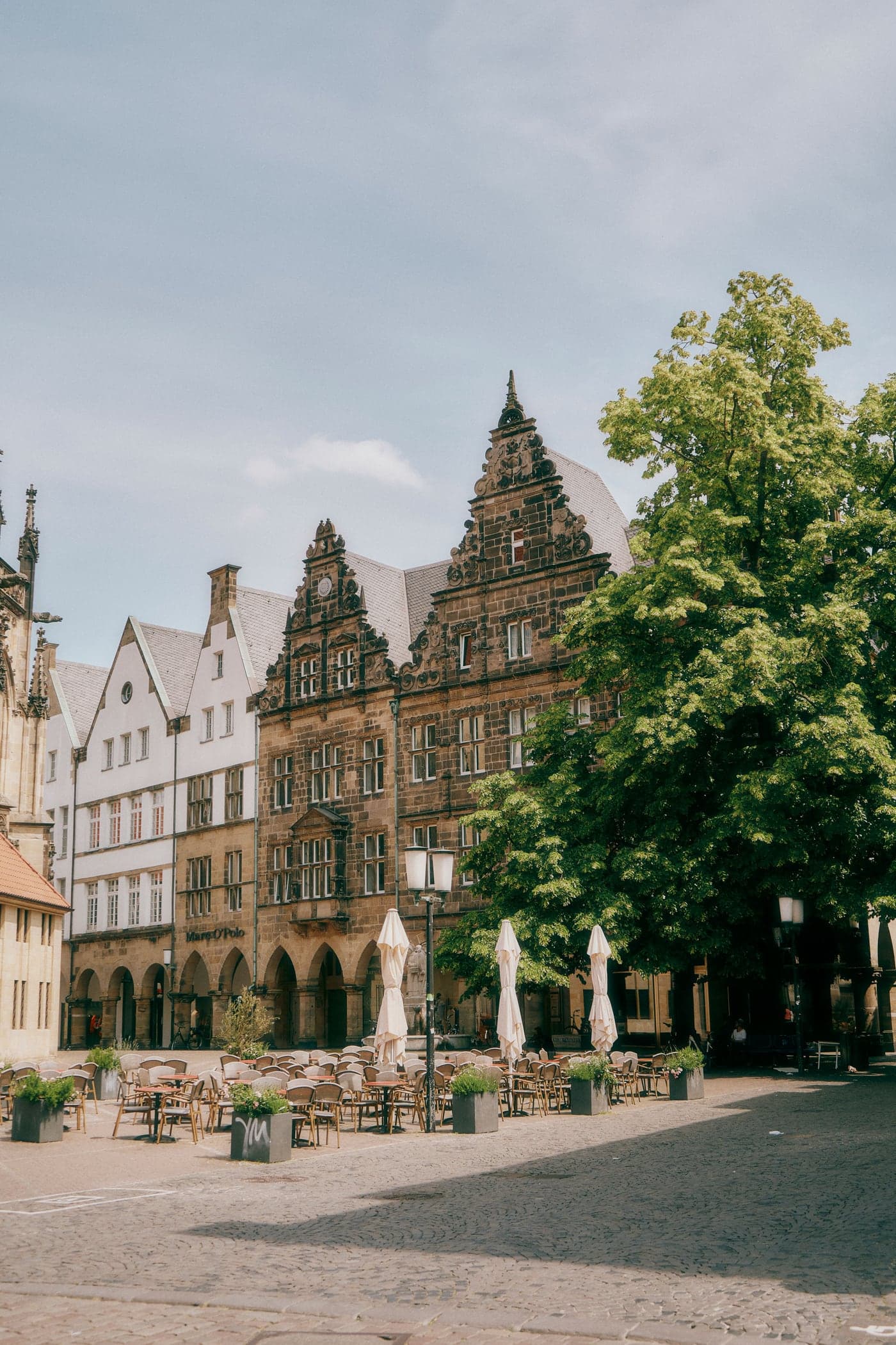 Gabled arcaded houses and café terraces on the Prinzipalmarkt in Münster, the street where the Volksbank-Münster-Marathon finishes