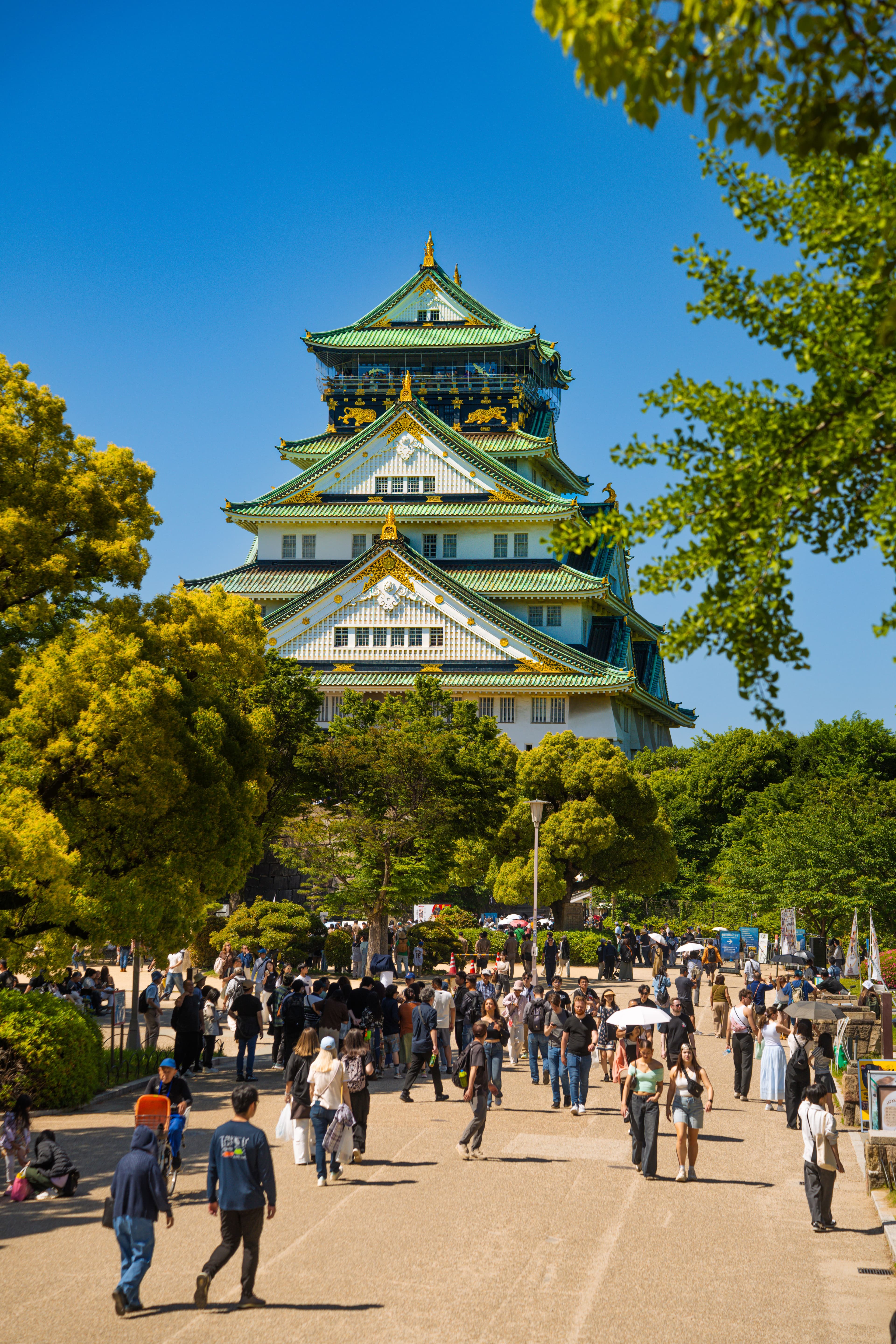 Osaka Castle's main tower seen from the park approach, a confirmed landmark on the Osaka Women's Marathon route