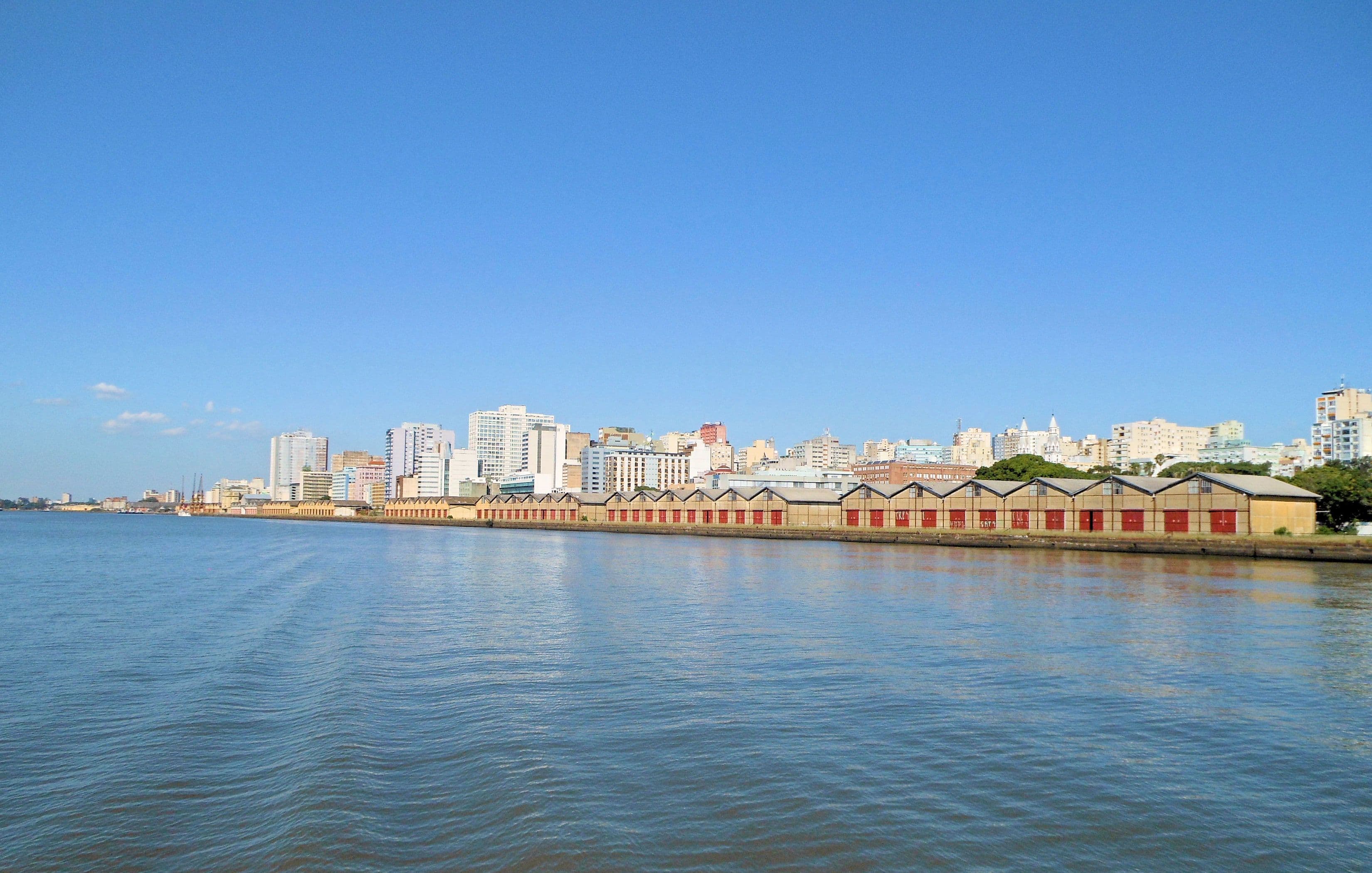 Porto Alegre skyline and the historic Cais do Porto warehouses along the Guaíba waterfront