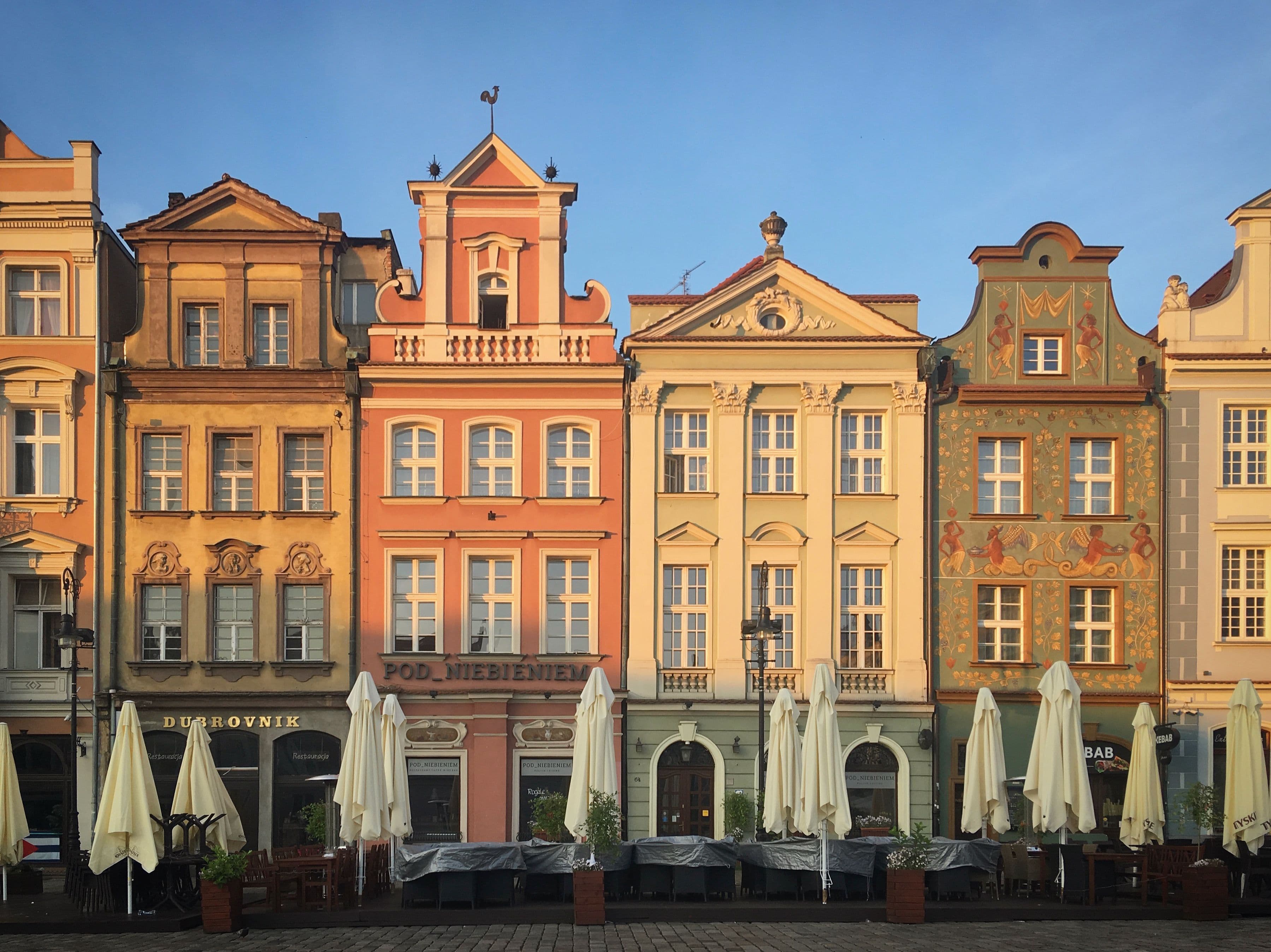 Colourful merchant houses on Poznań's Old Market Square (Stary Rynek) at golden hour, in the historic centre near the marathon route