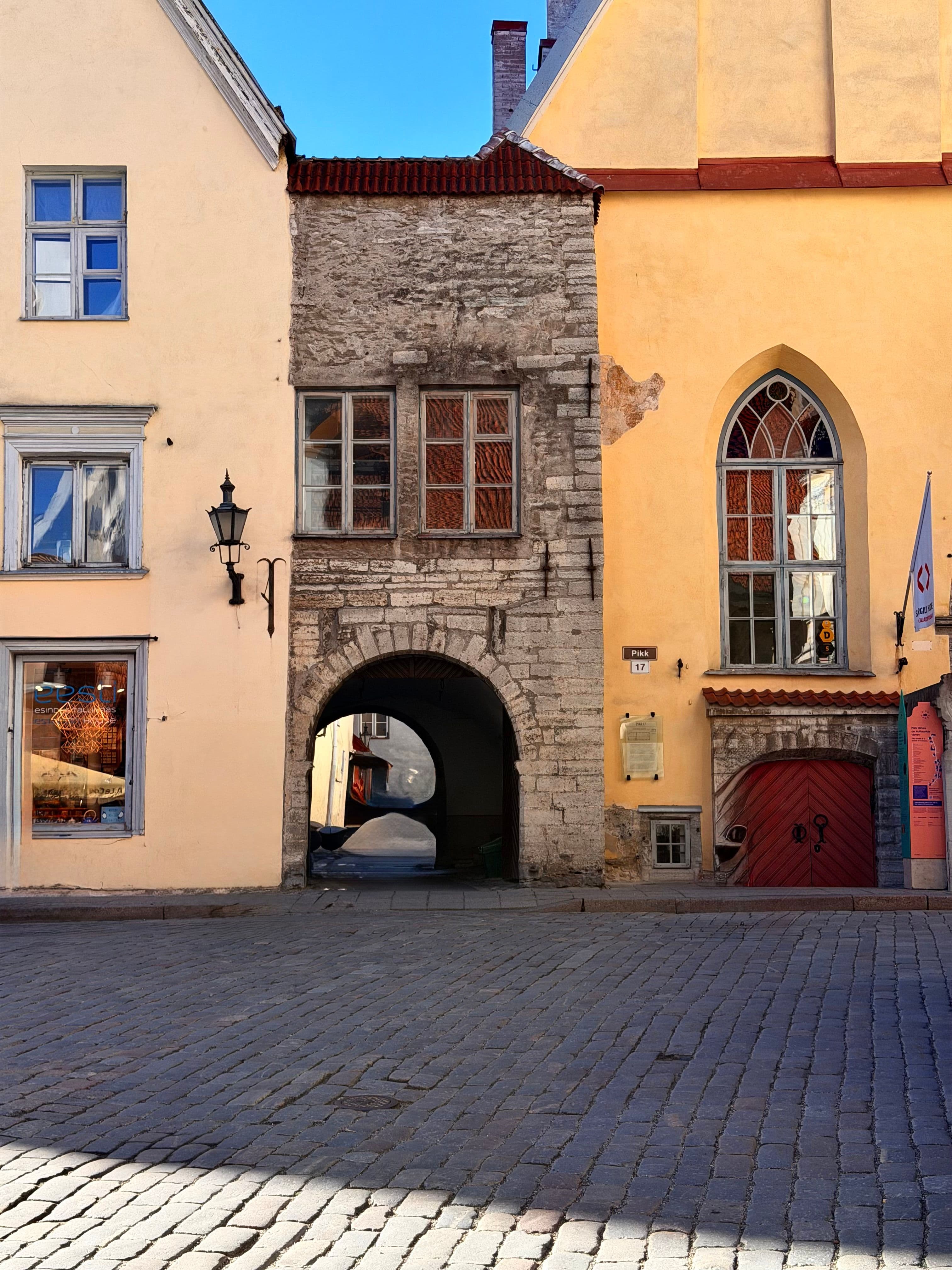 A stone archway on Pikk Street in Tallinn's Old Town, part of the marathon course through the medieval quarter