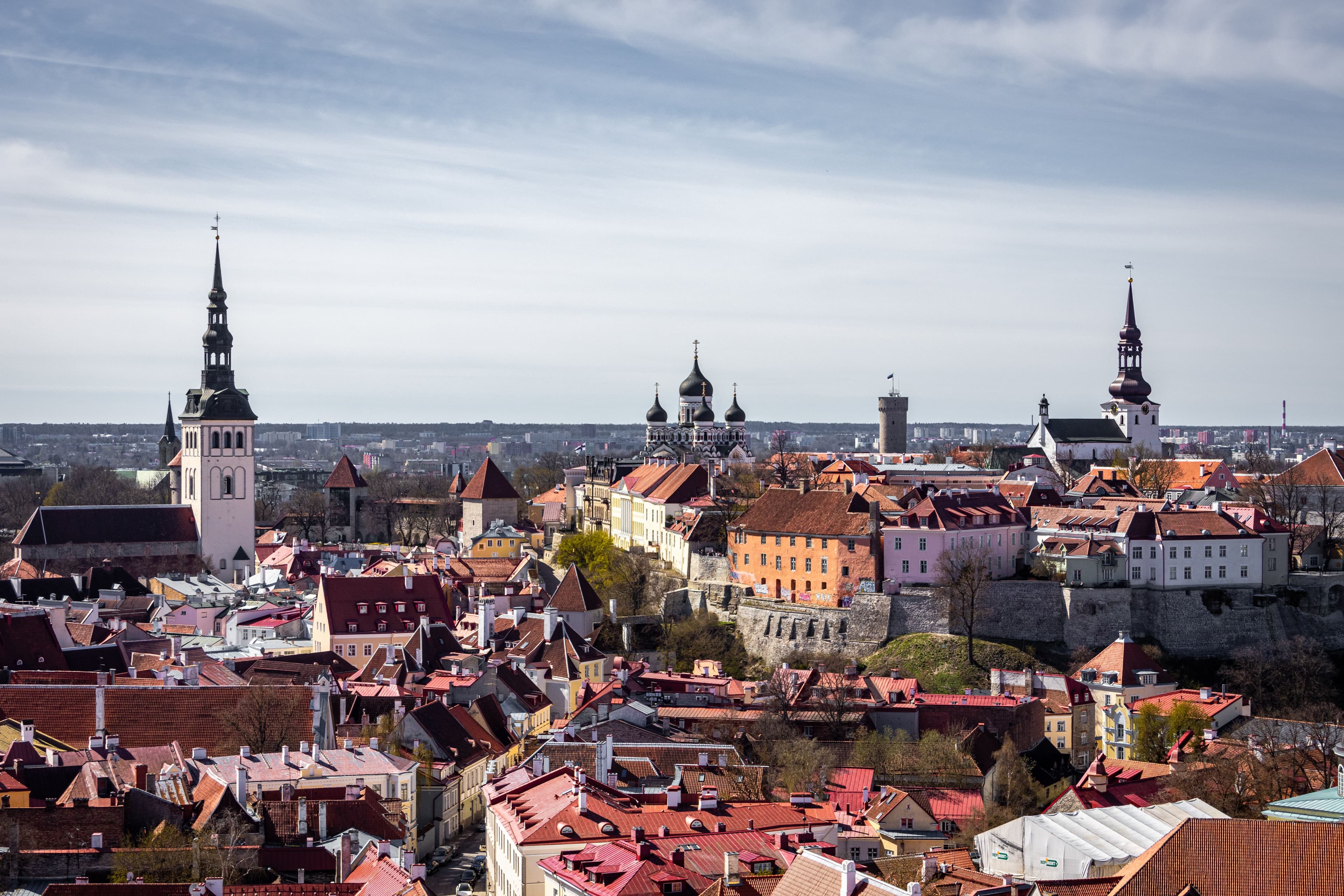 A skyline view of Tallinn's Old Town and Toompea hill, with Alexander Nevsky Cathedral and Tall Hermann Tower visible near the marathon finish