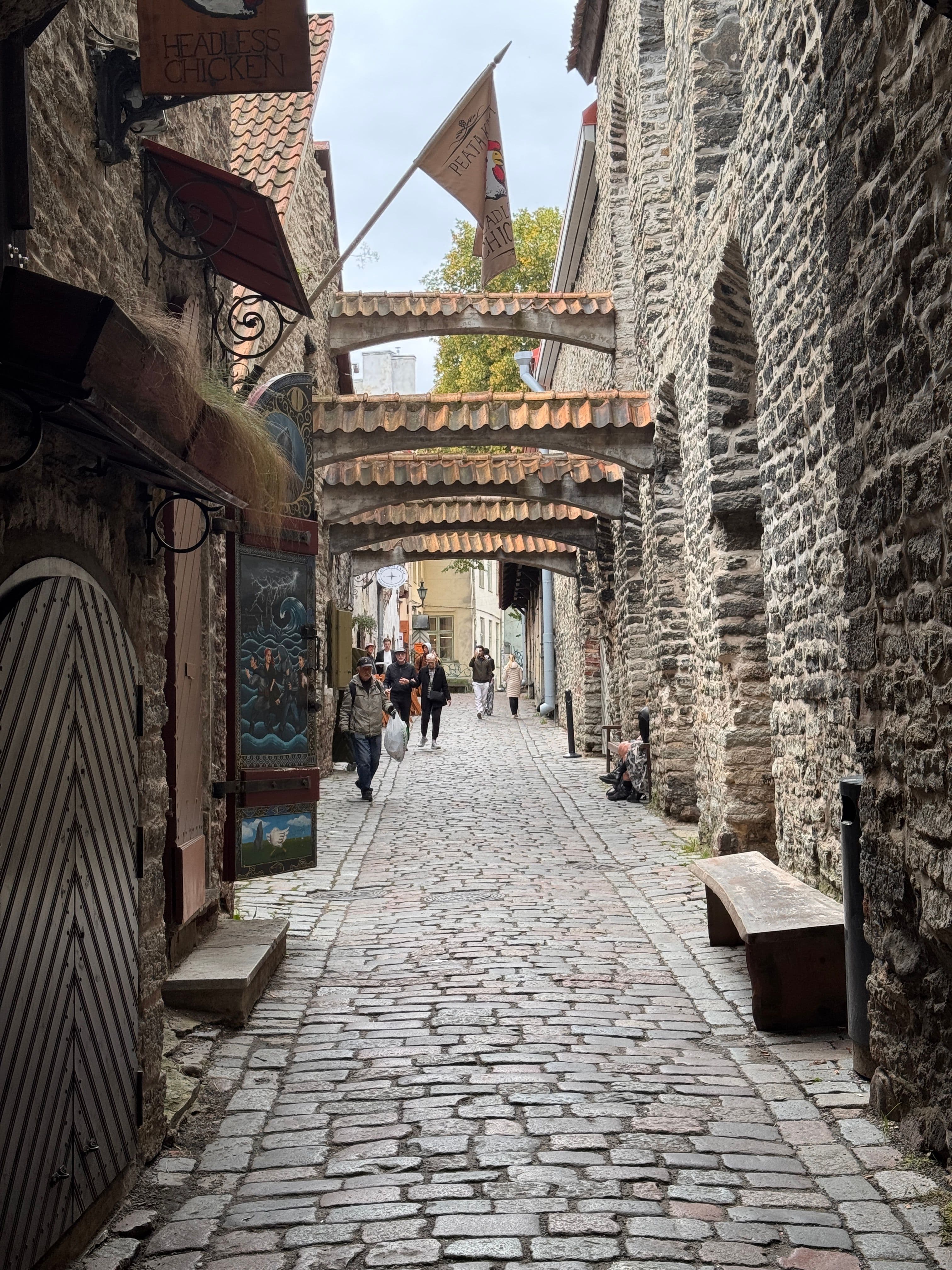 A cobbled medieval alley in Tallinn's Old Town, the UNESCO World Heritage district the marathon course runs through