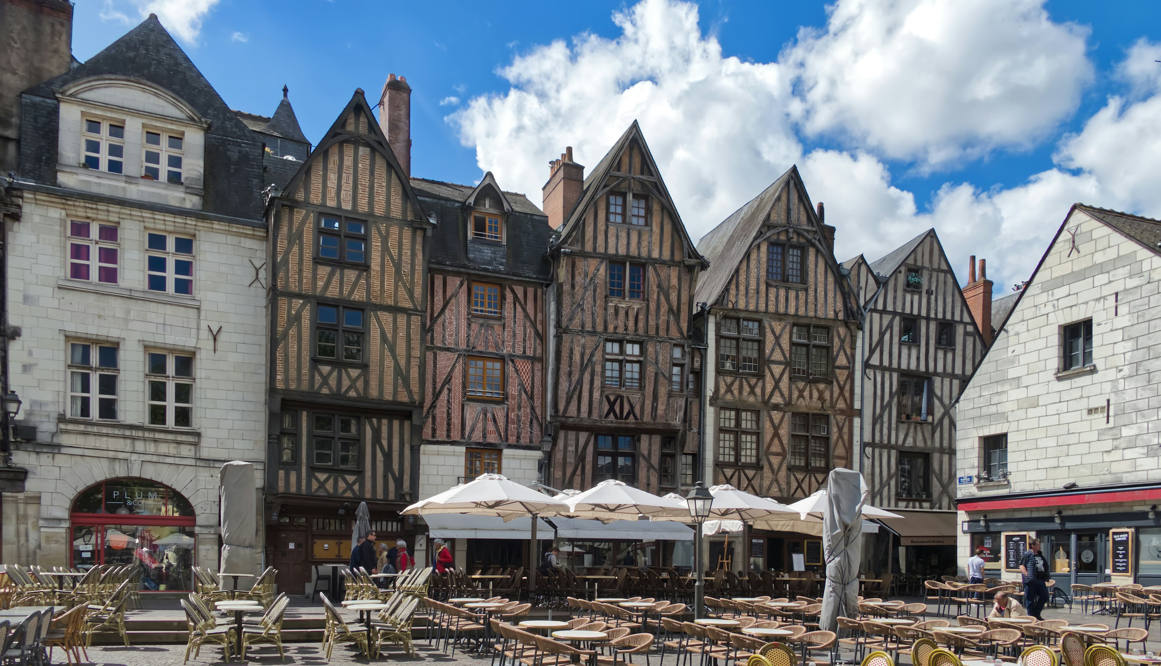 Half-timbered medieval houses and café terraces on Place Plumereau in Vieux Tours, the old quarter the Marathon de Tours runs back through in its closing kilometres before finishing at Place Anatole France